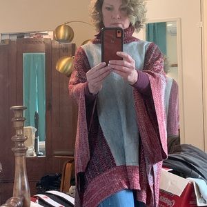 Sweater poncho in red and gray.
